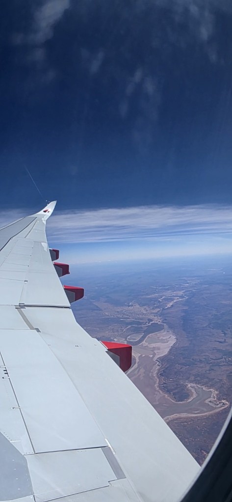 View of the airplane wing and sky on the journey to New Zealand