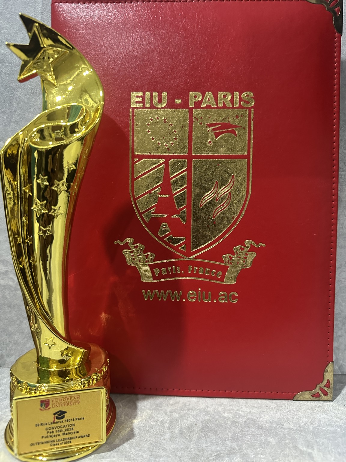 MBA certificate and Outstanding Leadership Award trophy