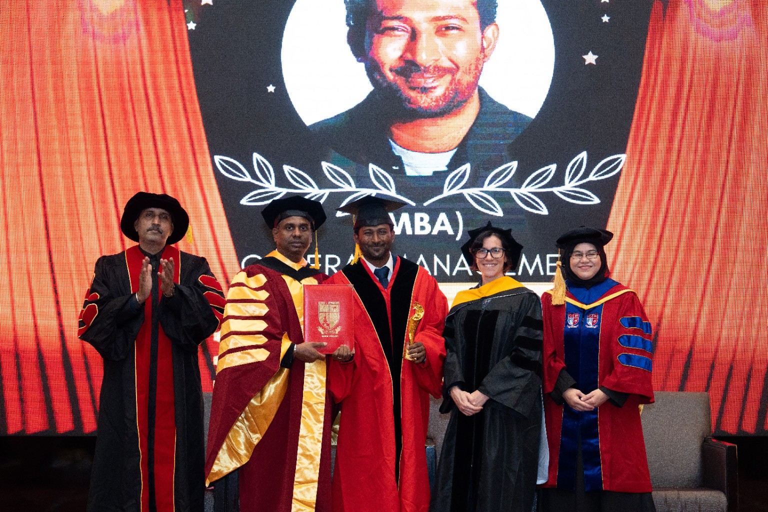 Thana receiving his MBA on the convocation stage