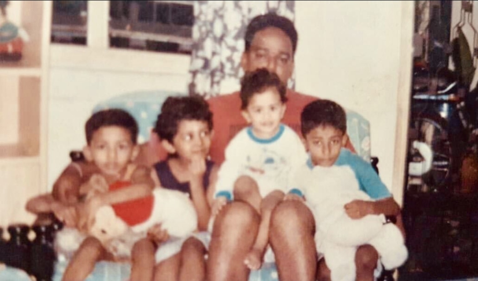 Thanaβs childhood family photograph with his dad and siblings