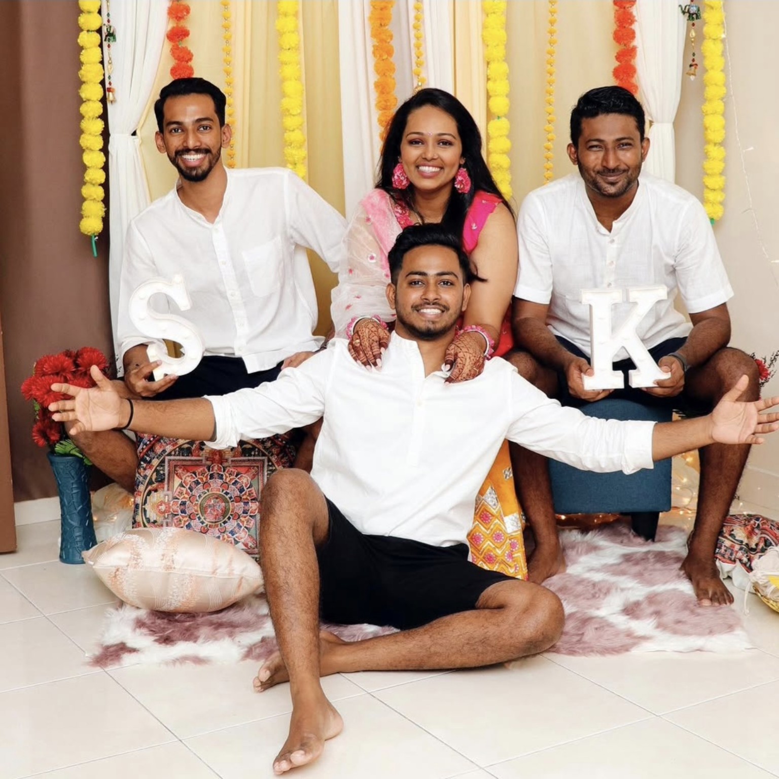 Thana seated with three family members