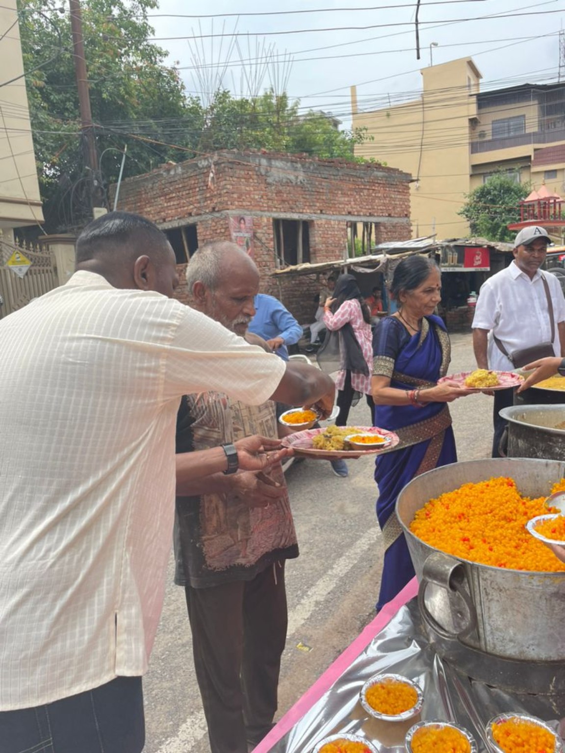Serving meals to people at the Sai Baba temple in Kashi