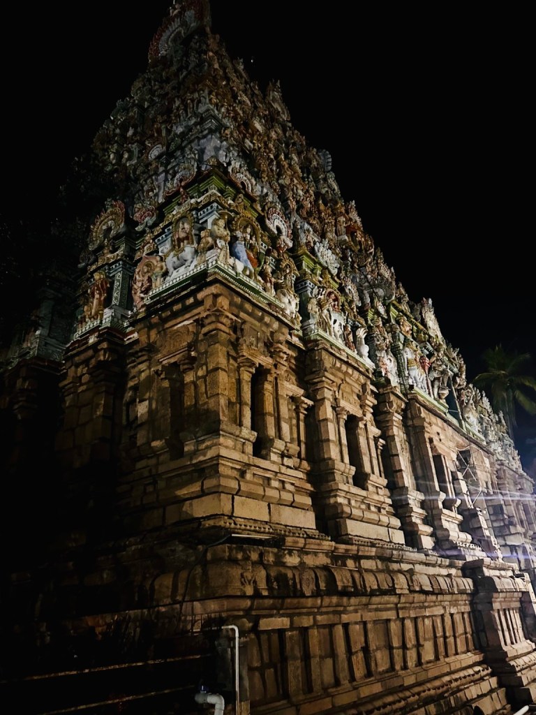 Carved temple tower against the night sky