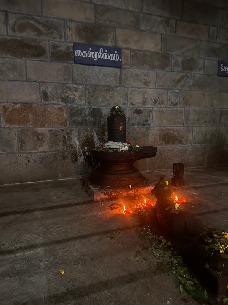 Oil lamps glowing beside a shrine