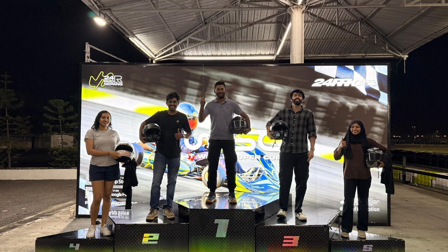 Thana on the first-place podium with his colleagues at Sepang