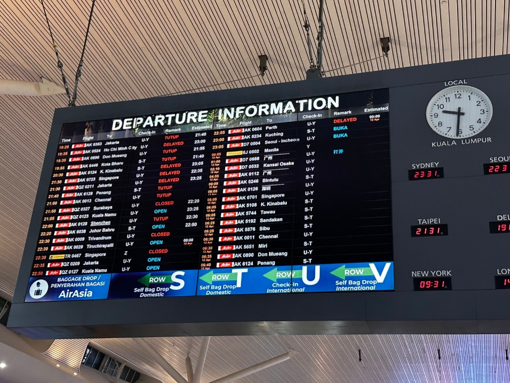 Airport departure information board listing destinations, flight times and gates