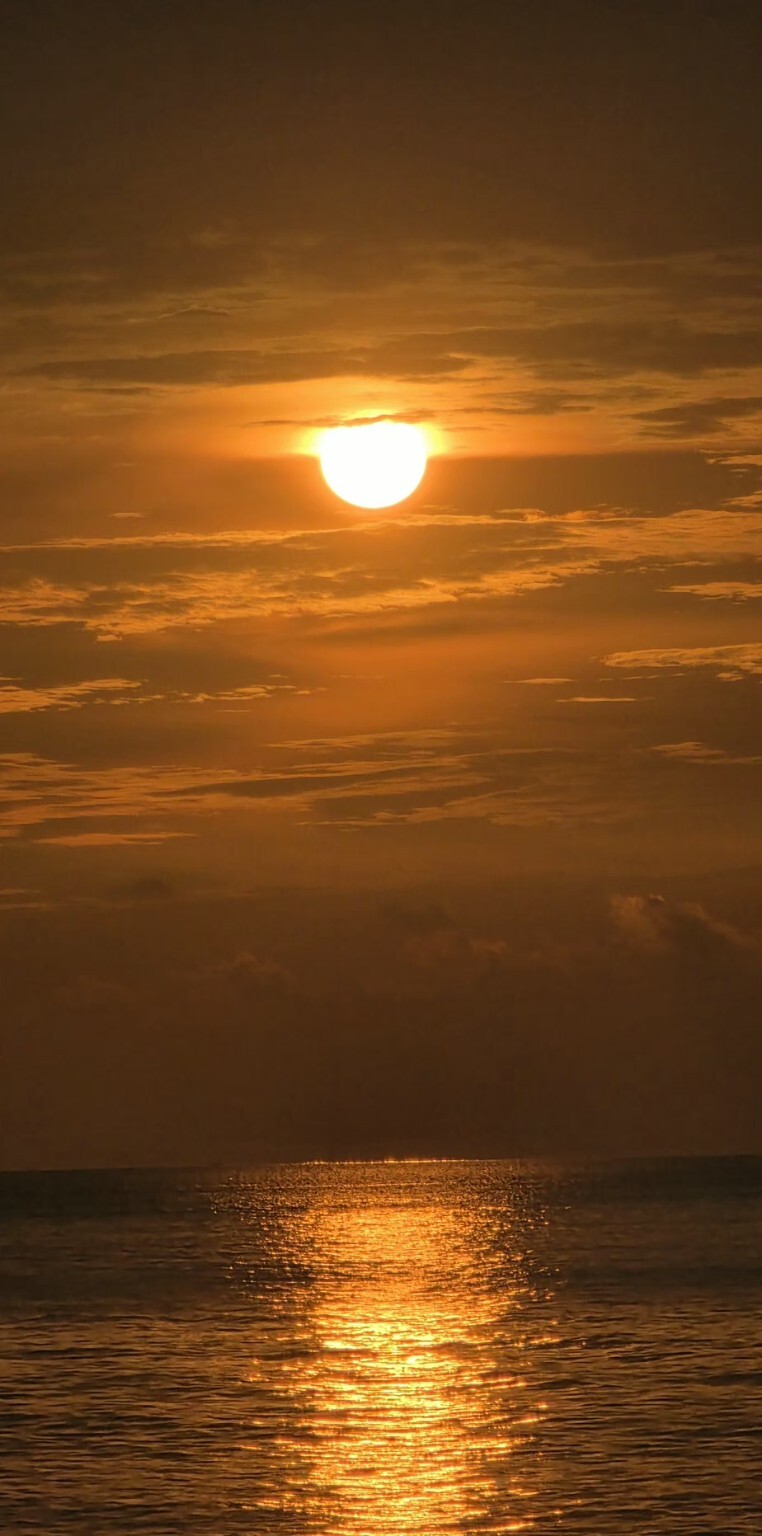 Golden sunset reflected on the sea at Batu Ferringhi, Penang