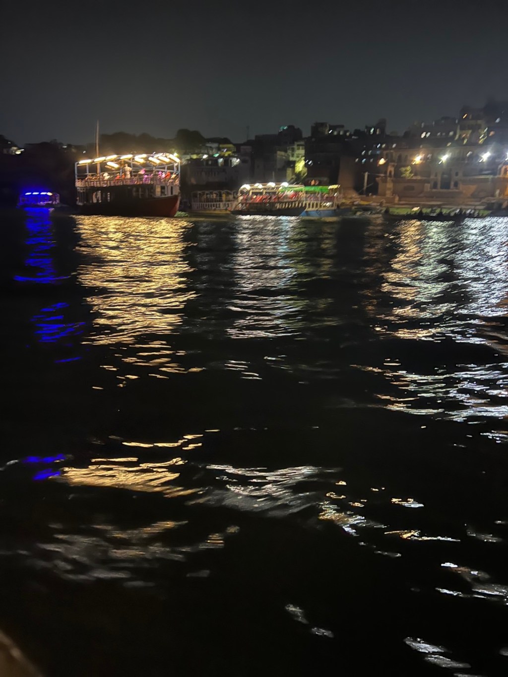 Lights reflected on the Ganga at night.