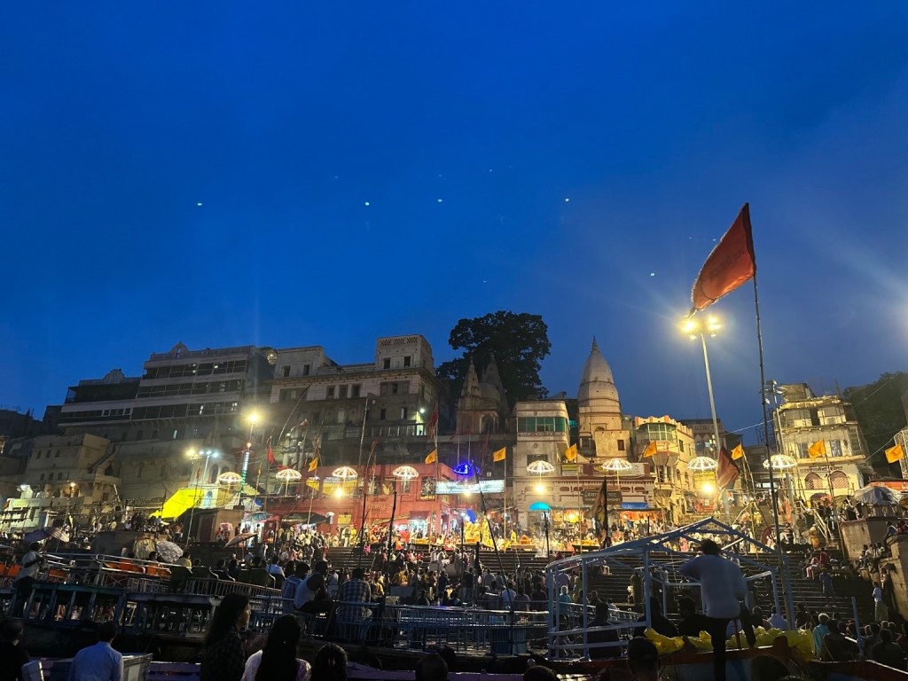 The illuminated ghats and people gathered for the evening aarti.