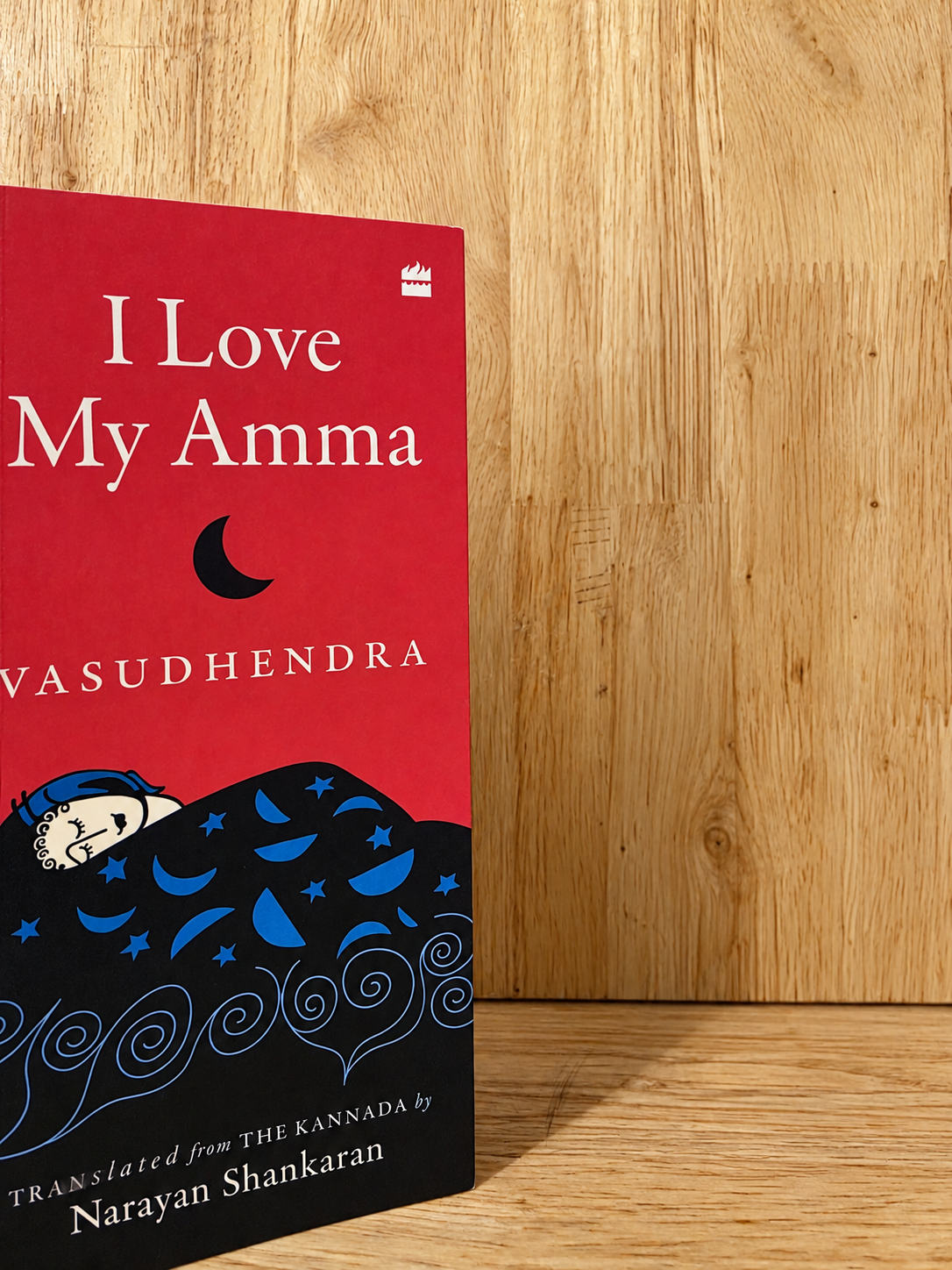 I Love My Amma by Vasudhendra, a red book against a wooden background