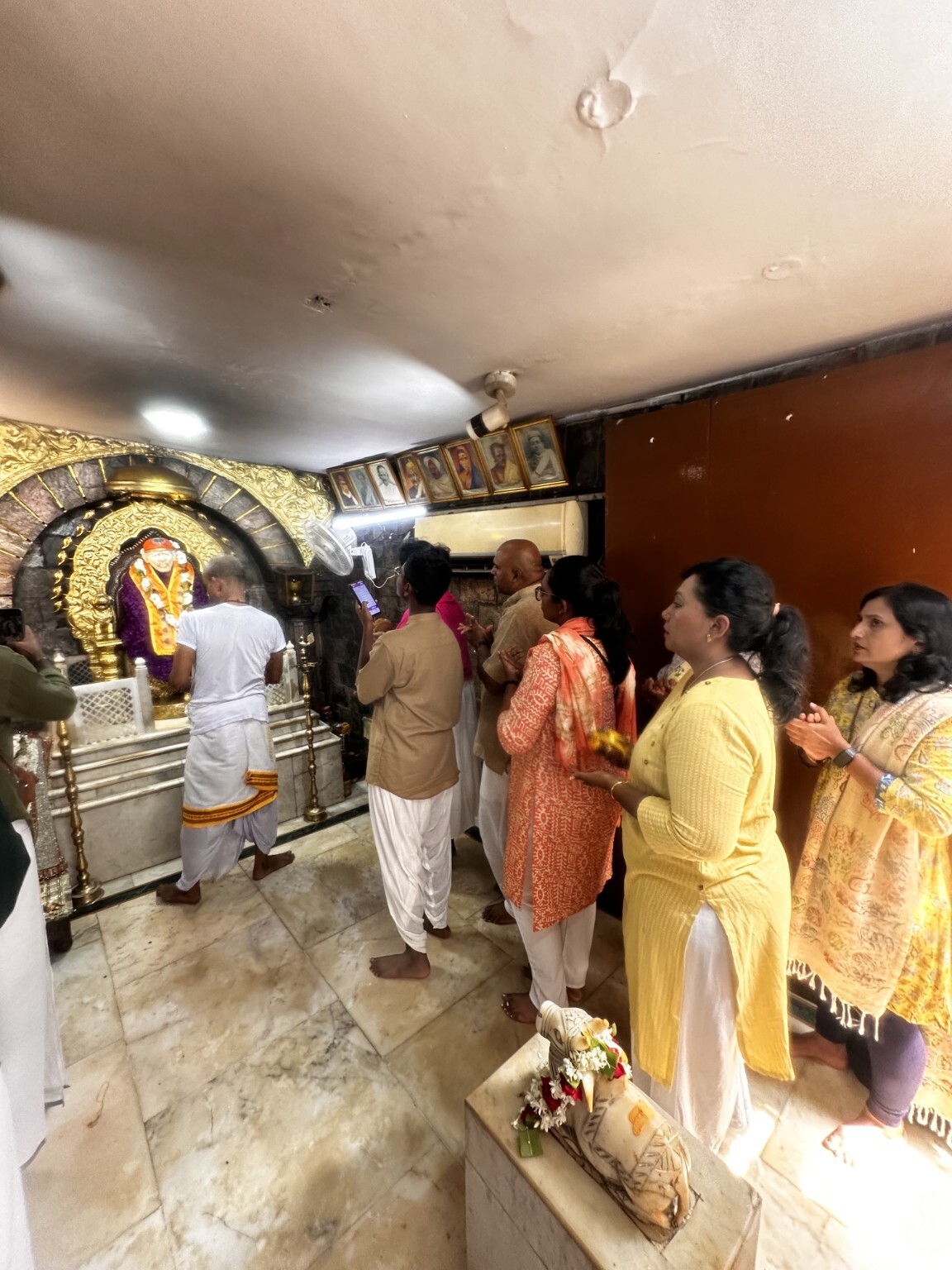 Family praying at the Sai Baba temple in Kashi