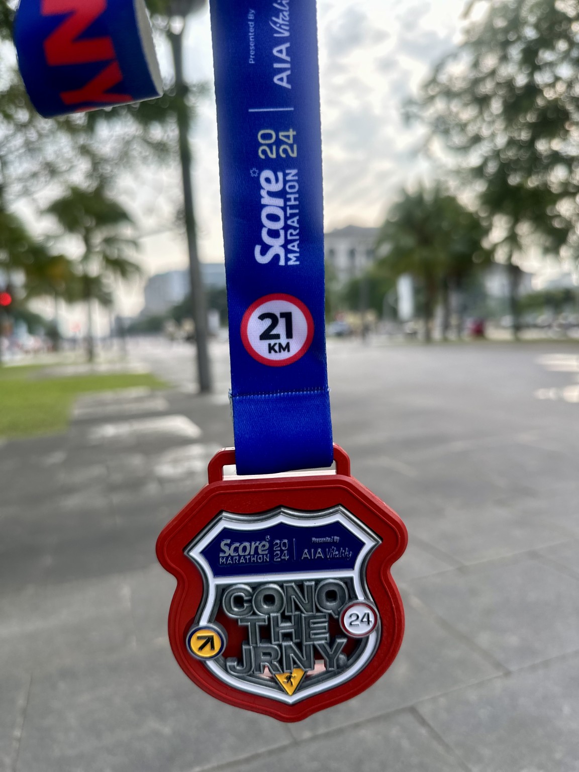 Close-up of the SCORE Marathon 2024 21km finisher medal.