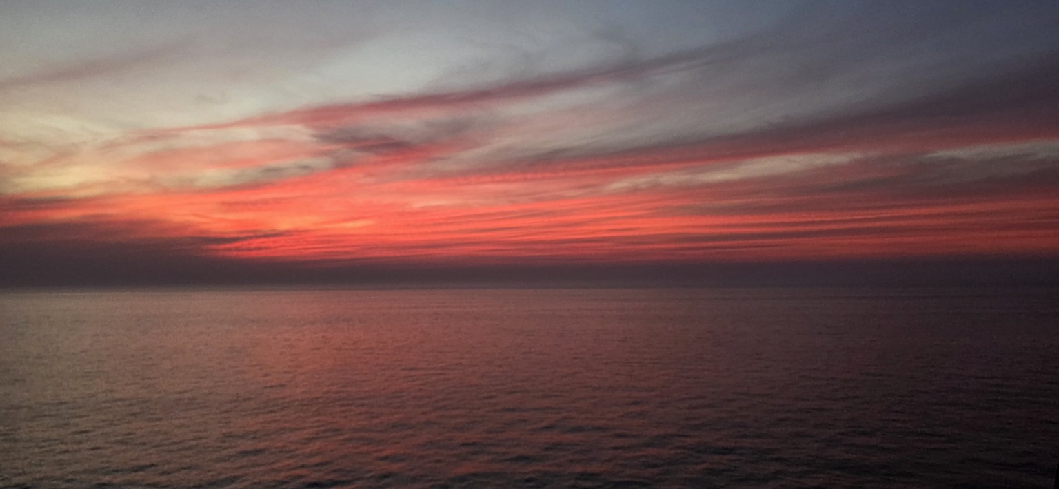 Red sunset over the sea on the ferry towards Surat, Gujarat